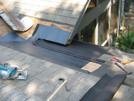 layers of new roofing felt are applied